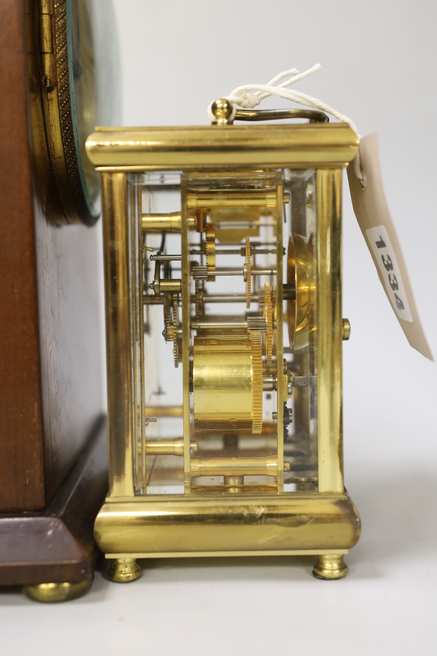 A brass presentation carriage clock together with an inlaid mahogany mantel clock